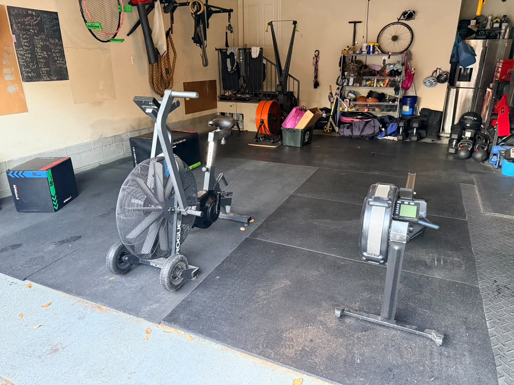 The Jane Street Gym home gym with rower and air bike on rubber flooring